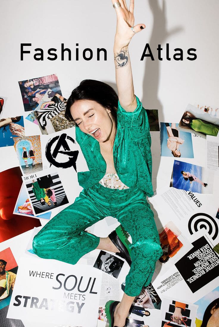 A woman in a vibrant green outfit joyfully poses with her arm raised, surrounded by fashion magazines and collages. The text "Fashion Atlas" and "Where Soul Meets Strategy" appear on the image. She has a tattoo on her forearm and is smiling with enthusiasm.